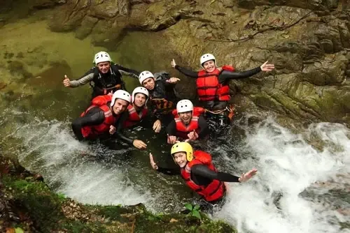 Familie mit Helmen und Neoprenanzügen bei einer Canyoning-Tour auf Madeira